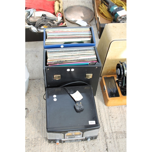 1811 - A PORTABLE RECORD PLAYER AND AN ASSORTMENT OF LP RECORDS