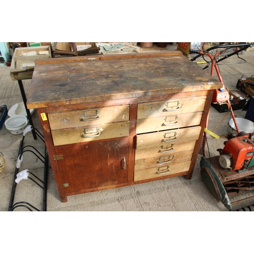 1814 - A VINTAGE WOODEN WORK BENCH WITH 8 DRAWERS AND A LOWER CUPBOARD (L:119CM)