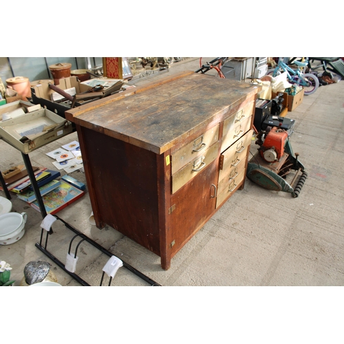 1814 - A VINTAGE WOODEN WORK BENCH WITH 8 DRAWERS AND A LOWER CUPBOARD (L:119CM)