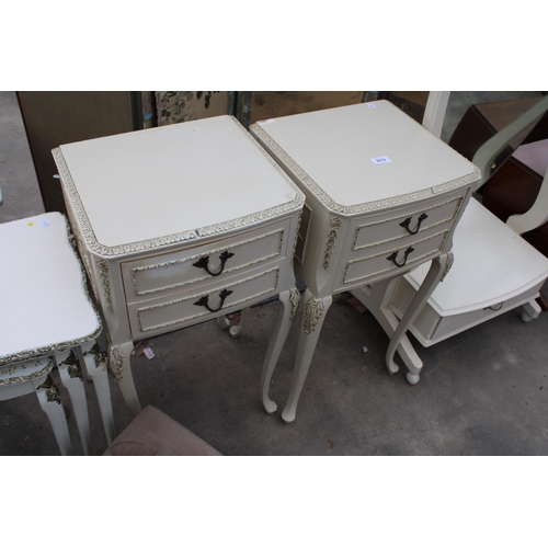 A PAIR OF CREAM AND GILT BEDSIDE TABLES, NEST OF TWO TABLES AND A POUFFE