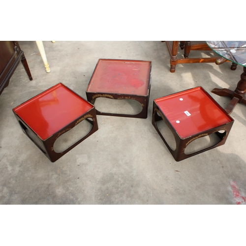 2903 - A SET OF THREE ORIENTAL STACKING TABLES WITH CHINOISERIE DECORATION