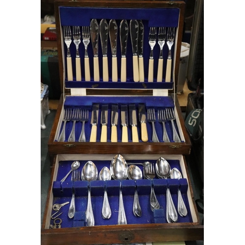 1005 - A VINTAGE CANTEEN OF CUTLERY IN A MAHOGANY CASE WITH BOTTOM DRAWER