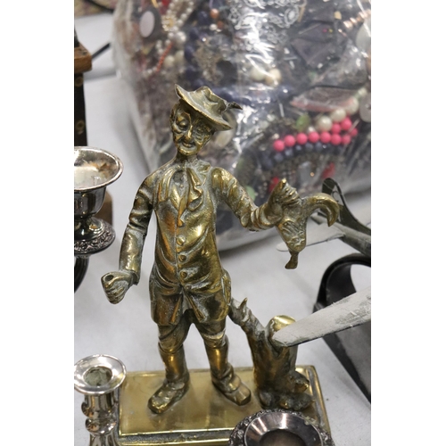 991 - A QUANTITY OF BRASS AND SILVER PLATE TO INCLUDE A HEAVY POACHER FIGURE, CANDLESTICKS, ANIMAL FIGURES... 