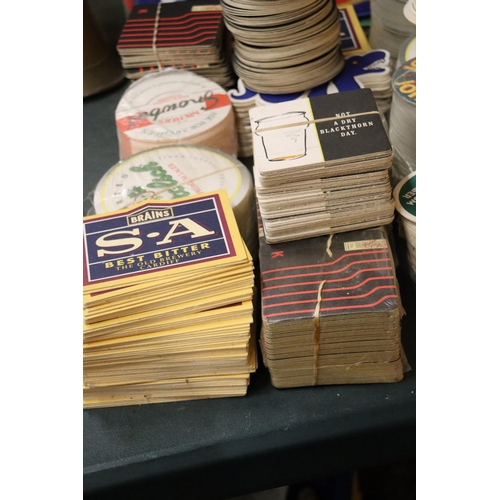 999 - FOUR BEER TOWELS PLUS A LARGE QUANTITY OF BEER MATS