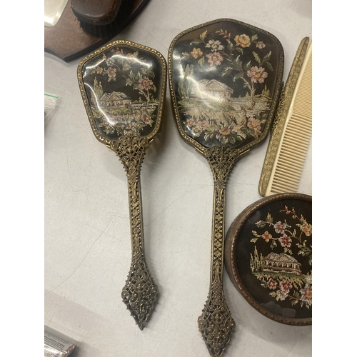 150A - A VINTAGE PETIT POINT DRESSING TABLE SET TO INCLUDE BRUSHES, A COMB, HAND MIRROR AND TRINKET POT