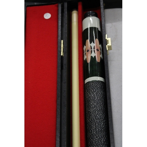 1205 - A DECORATIVE POOL CUE IN  A HARD CASE