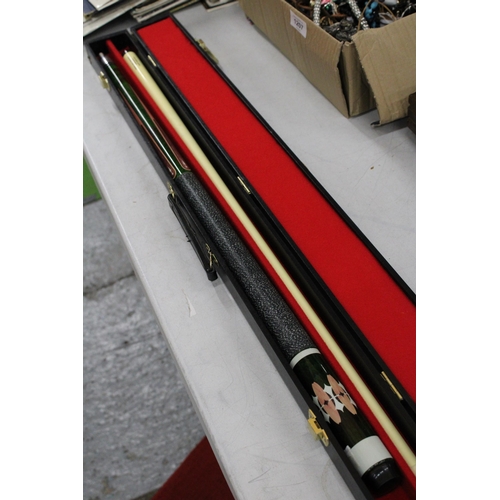 1205 - A DECORATIVE POOL CUE IN  A HARD CASE