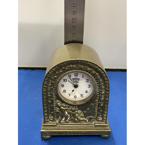 81 - AN ITALIAN CLASSICAL BRASS MANTLE CLOCK WITH CHERUB DESIGN HEIGHT 12CM