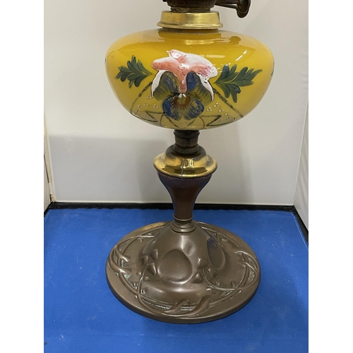 83 - AN ART NOUVEAU COPPER AND PAINTED GLASS OIL LAMP