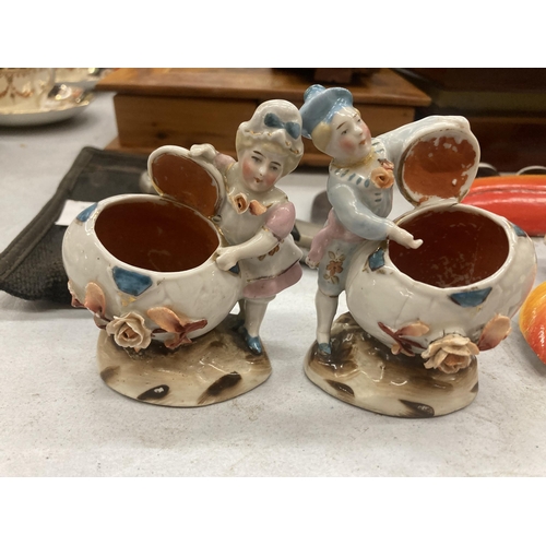 243 - TWO VINTAGE GERMAN CONTA AND BOHME MATCHSTICK HOLDER FAIRINGS DEPICTING A LADY AND A MAN WITH AN OPE... 