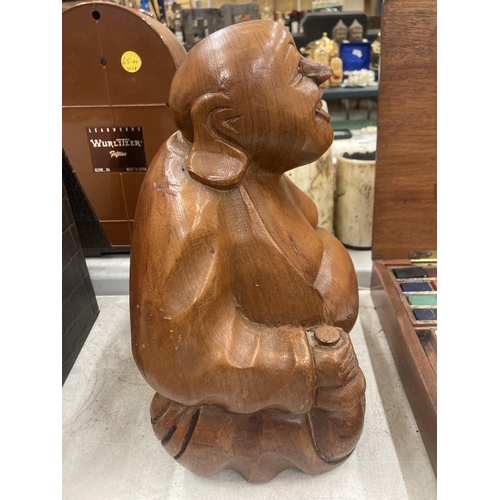 266 - A LARGE WOODEN HAND CARVED BUDDHA