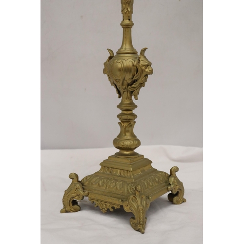 299A - A VINTAGE STYLE HEAVY BRASS CANDLE HOLDER, HEIGHT 55CM