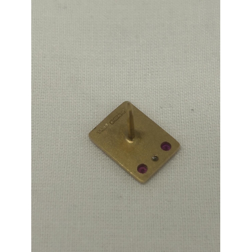 545 - A HALLMARKED 9CT GOLD DIAMOND AND RUBY 'FODEN' PIN BADGE GROSS WEIGHT 4.84G