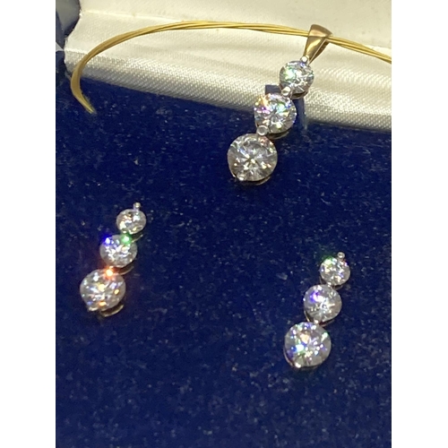 564 - A SILVER CUBIC ZIRCONIA PENDANT AND EARRING SET IN A PRESENTATION BOX