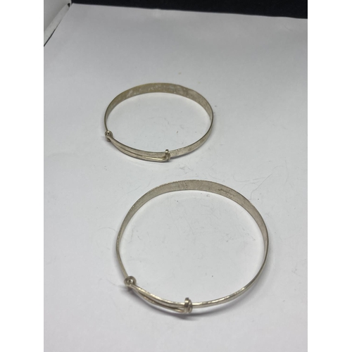 581 - TWO SILVER BANGLES