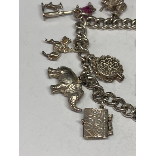 639 - A SILVER CHARM BRACELET WITH TWELVE CHARMS