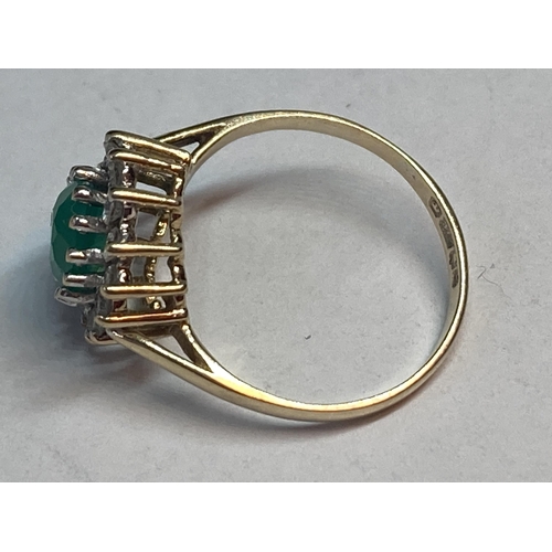 691 - A 9 CARAT GOLD RING WITH CENTRE GREEN STONE SURROUNDED BY CUBIC ZIRCONIAS SIZE K