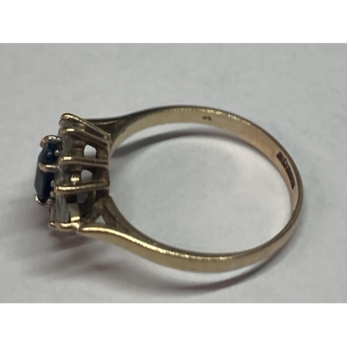 701 - A 9 CARAT GOLD RING WITH A CENTRE SAPPHIRE SURROUNDED BY CUBIC ZIRCONIAS SIZE M