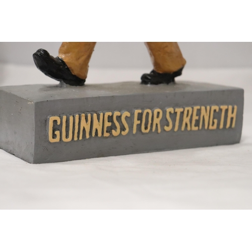 858 - A RESIN FIGURE, 'GUINNESS FOR STRENGTH', HEIGHT 36CM, WIDTH 34CM