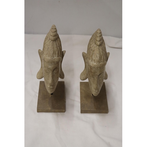 861 - TWO BUDDAH HEADS ON STANDS, HEIGHT 27CM