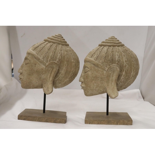 861 - TWO BUDDAH HEADS ON STANDS, HEIGHT 27CM