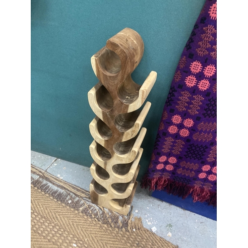 873 - A DESIGNER HARDWOOD WINE RACK, CARVED FROM ONE PIECE OF WOOD, HEIGHT 1 METRE