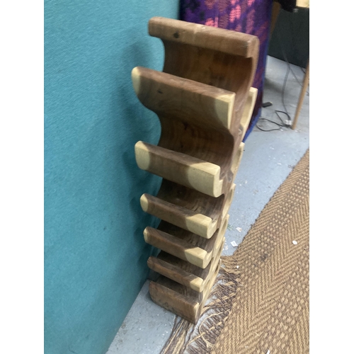 873 - A DESIGNER HARDWOOD WINE RACK, CARVED FROM ONE PIECE OF WOOD, HEIGHT 1 METRE