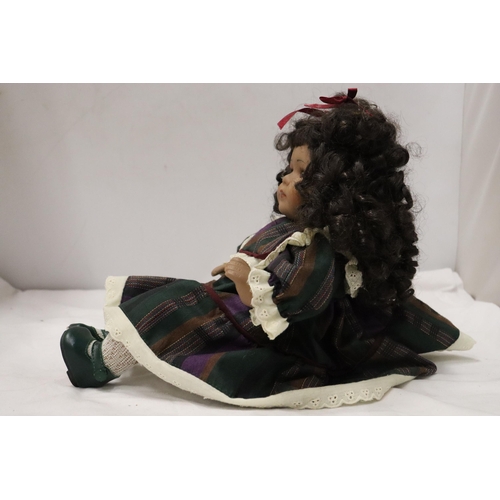 901 - A VINTAGE CHINA DOLL IN SEATED POSE