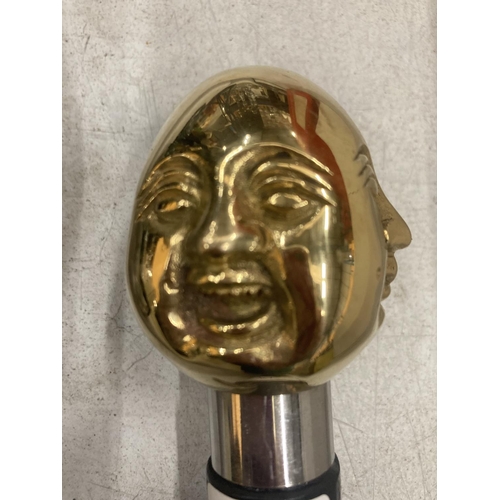 926 - A BRASS FOUR FACED BUDDHA HANDLE WALKING STICK