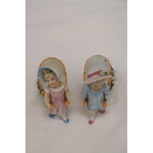 963 - TWO VINTAGE CONTA AND BOHME GERMAN FAIRINGS TO INCLUDE TWO GIRLS PULLING FLOWER CARTS, ONE WITH A HA... 