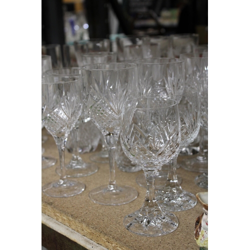 1265 - A QUANTITY OF CUT GLASS, GLASSES TO INCLUDE CHAMPAGNE FLUTES, WINE, BRANDY, SHERRY, ETC