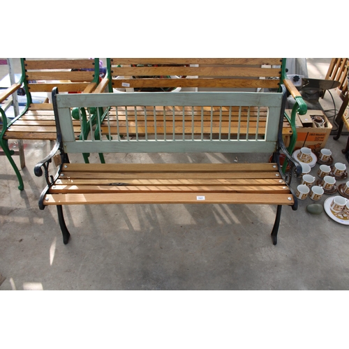 1921 - A WOODEN SLATTED GARDEN BENCH WITH DECORATIVE CAST BENCH ENDS