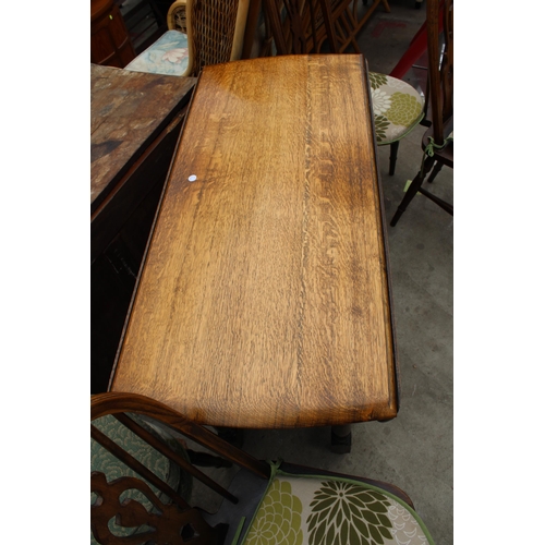 2669 - AN OVAL OAK GATELEG DINING TABLE AND FOUR ERCOL STYLE WINDSOR CHAIRS