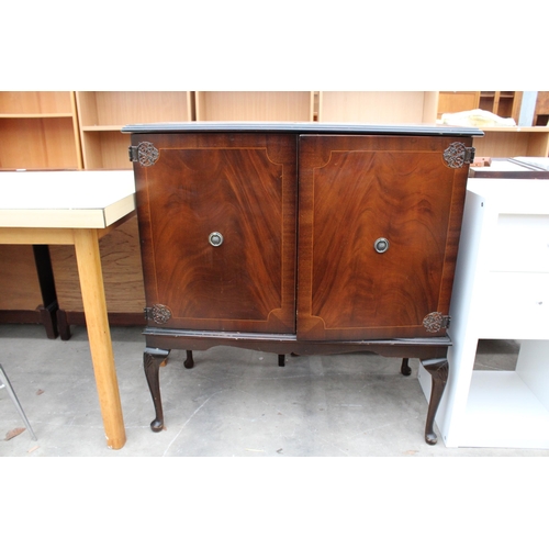 2843 - A MAHOGANY CABINET, WITH A QUANTITY OF DVDs AND VIDEOS