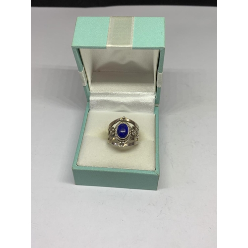 530 - A BOXED SILVER PURPLE STONE RING