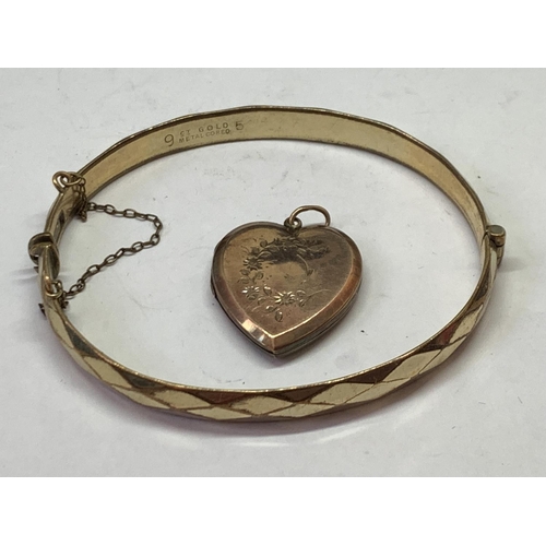 547 - TWO 9 CARAT GOLD PLATED ITEMS - A BANGLE AND A HEART SHAPED LOCKET