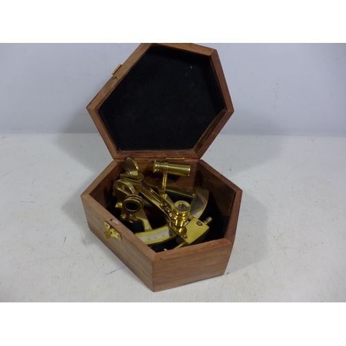 437 - A CASED SMALL BRASS SEXTANT