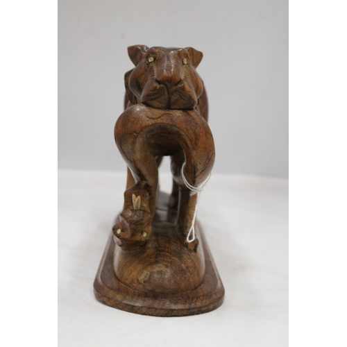 139 - A CARVED WOODEN BIG CAT WITH A SNAKE, HEIGHT 17CM, LENGTH 28CM