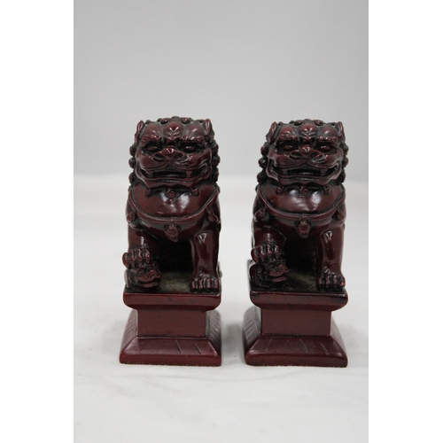 148 - A PAIR OF HEAVY SOLID ORIENTAL FOO DOGS, HEIGHT 11CM