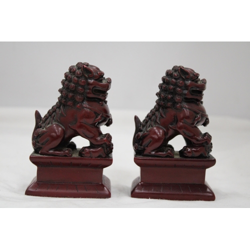 148 - A PAIR OF HEAVY SOLID ORIENTAL FOO DOGS, HEIGHT 11CM