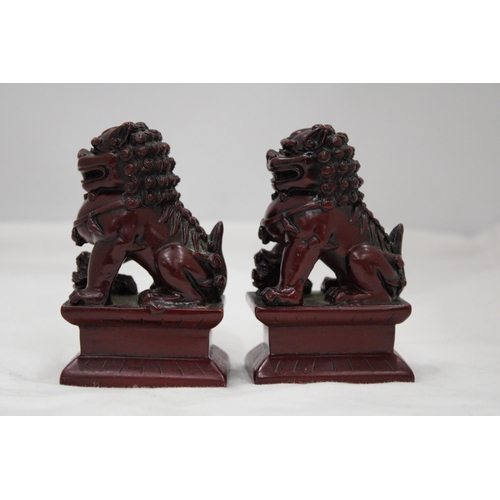 148 - A PAIR OF HEAVY SOLID ORIENTAL FOO DOGS, HEIGHT 11CM