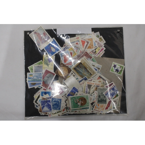 437 - A QUANTITY OF LOOSE STAMPS FROM AROUND THE WORLD