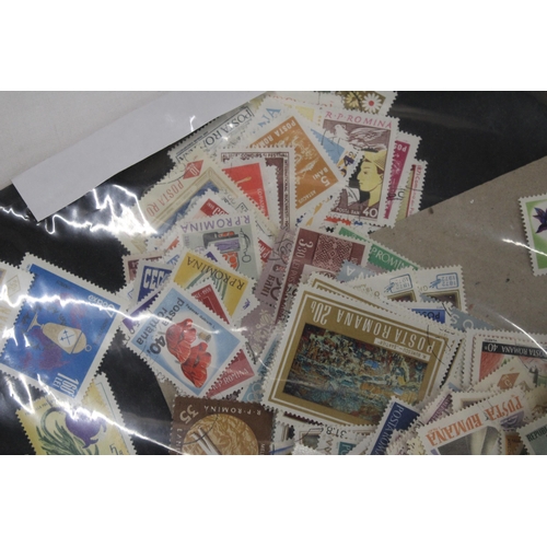 437 - A QUANTITY OF LOOSE STAMPS FROM AROUND THE WORLD