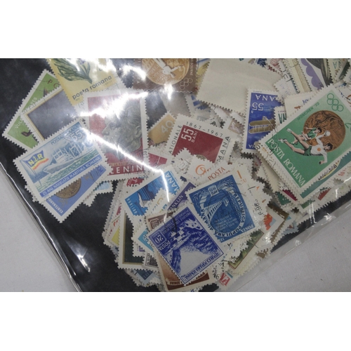 437 - A QUANTITY OF LOOSE STAMPS FROM AROUND THE WORLD