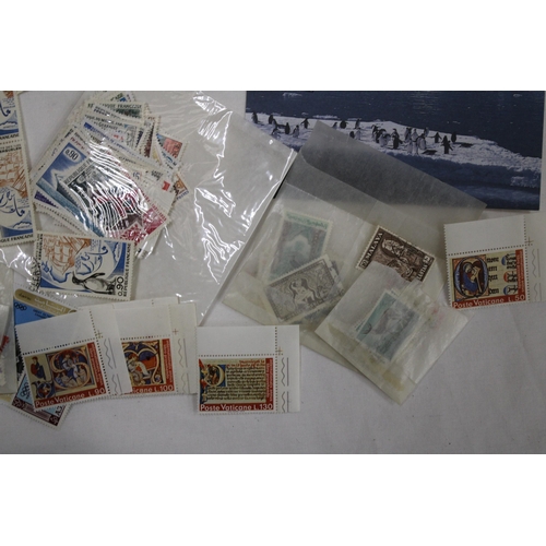 438 - A QUANTITY OF STAMPS IN PACKETS FROM AROUND THE WORLD