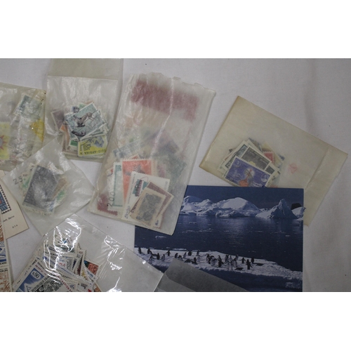 438 - A QUANTITY OF STAMPS IN PACKETS FROM AROUND THE WORLD