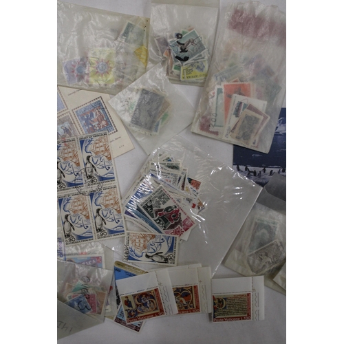 438 - A QUANTITY OF STAMPS IN PACKETS FROM AROUND THE WORLD