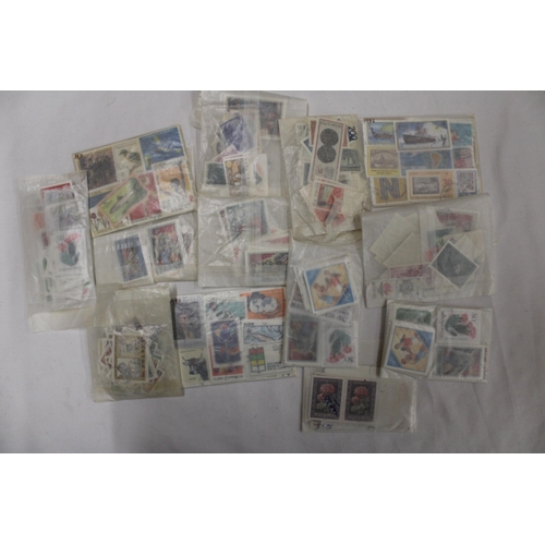 439 - A QUANTITY OF STAMPS IN PACKETS FROM AROUND THE WOR4LD