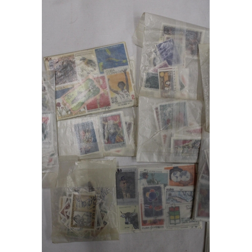 439 - A QUANTITY OF STAMPS IN PACKETS FROM AROUND THE WOR4LD