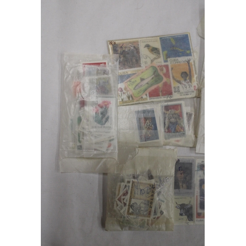 439 - A QUANTITY OF STAMPS IN PACKETS FROM AROUND THE WOR4LD